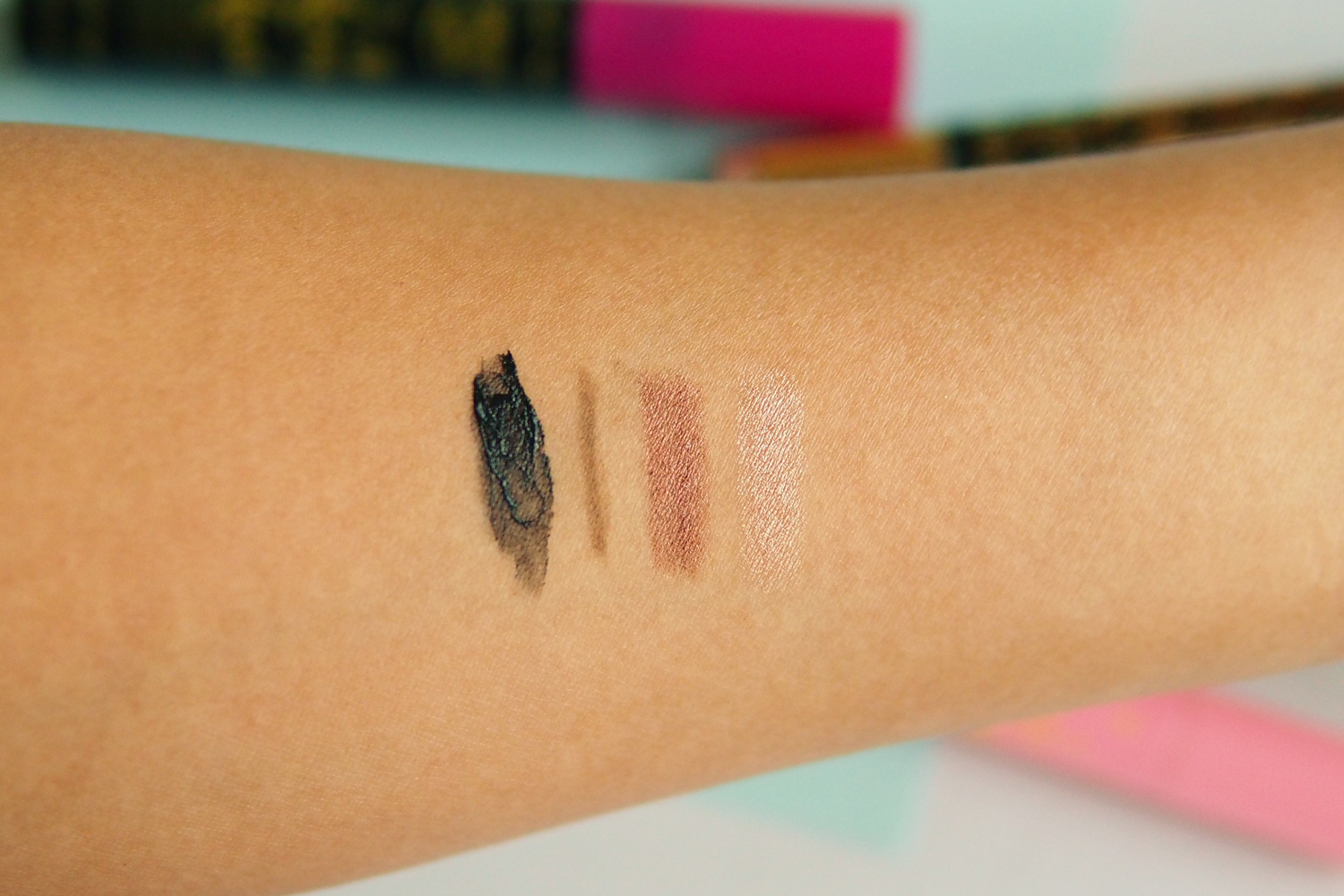 Swatches, from left: At Long Lash Supercurl Waterproof Mascara, Eye Love View Too Microtip Eyebrow Pencil & Spoolie Duo, Say Eye Do Easy Eyeshadow Cushion Duo in Espresso and in Champagne