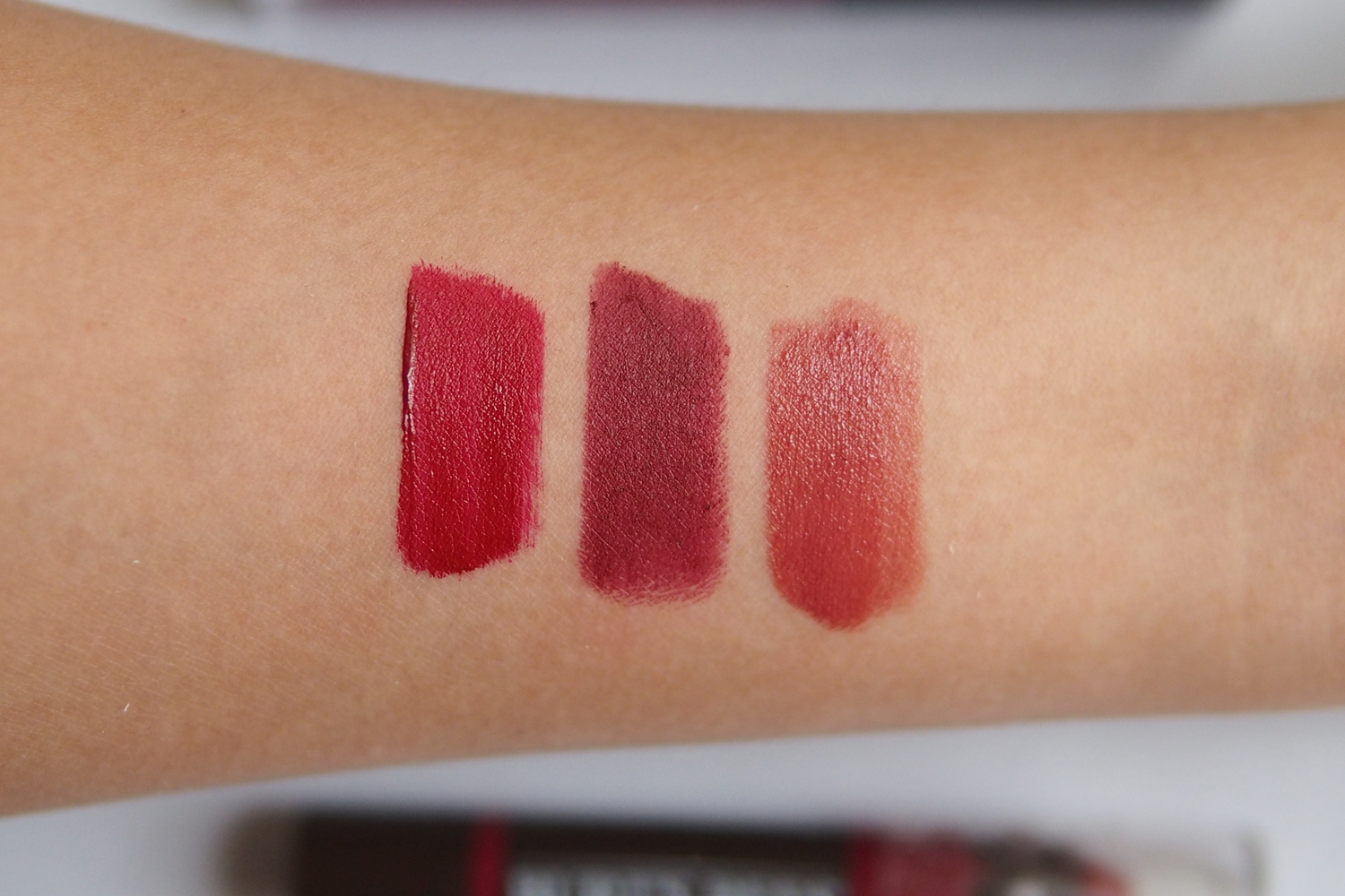 From left: Ellana Liquid Lipstick in Love Is Tru e, L’Oreal Rouge Magique Lipstick in Purple Comtess e, Burt’s Bees Matte Lip Crayon in Redwood Forest