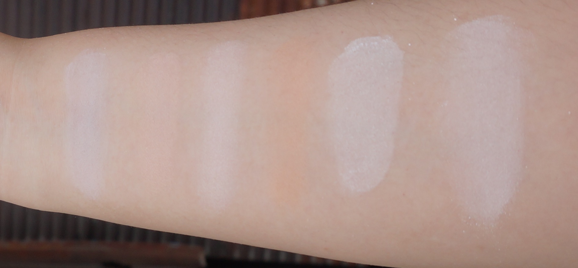 Swatches from left: Essence Colour Correcting Matt Pearls (swirled together), Hourglass Ambient Lighting Powders in Dim Light , Incandescent Light , and Radiant Light , Make Up For Ever Ultra HD Loose Powder, Guerlain Meteorites in 02 Clair (swirled together)