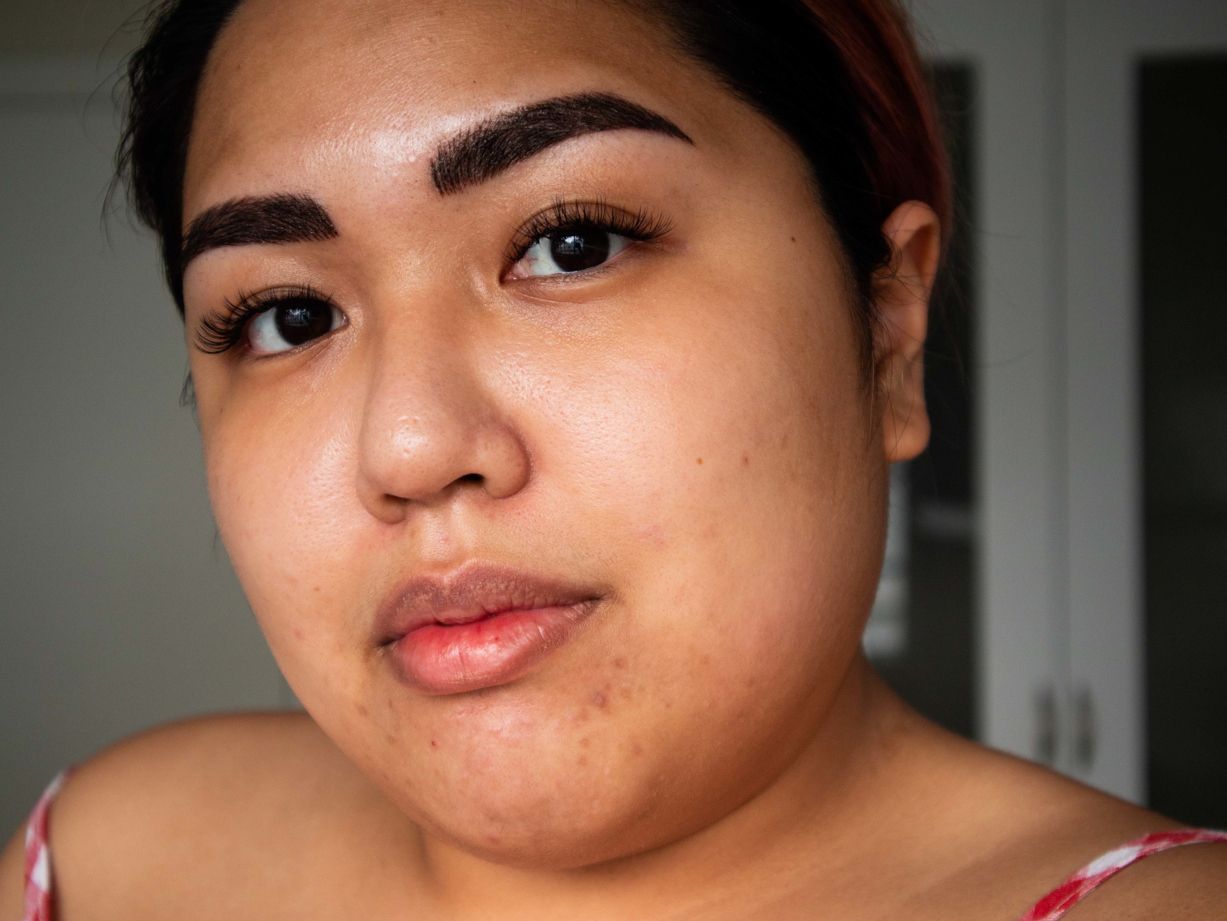 Bare faced with freshly-microbladed brows and new lash extensions