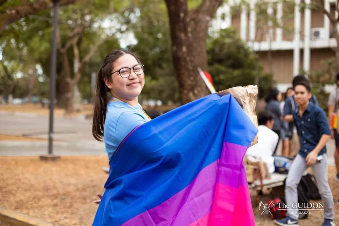 Moosh holding the Pride flag