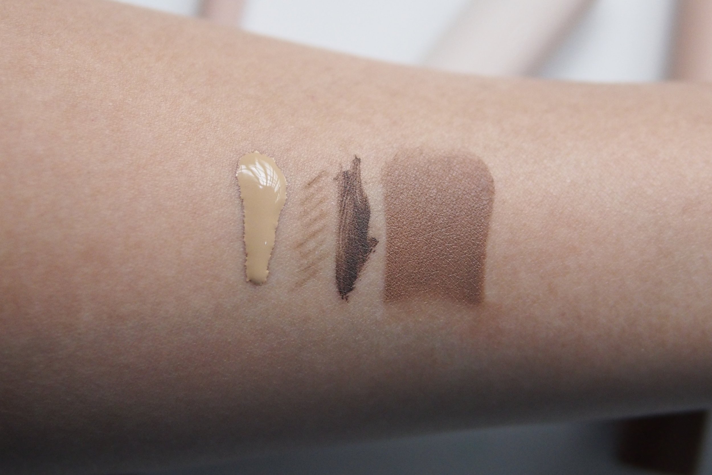 Swatches, from left: Skin Tint Sun Shield in Butterscotch, Universal Brow Stick Pencil + Mascara in Taupe, Multitasking Color Stick in Cocoa