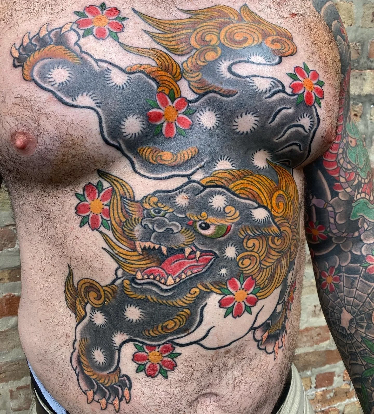 Foo Dog chest tattoo Chip Douglas Great Lakes Tattoo 
