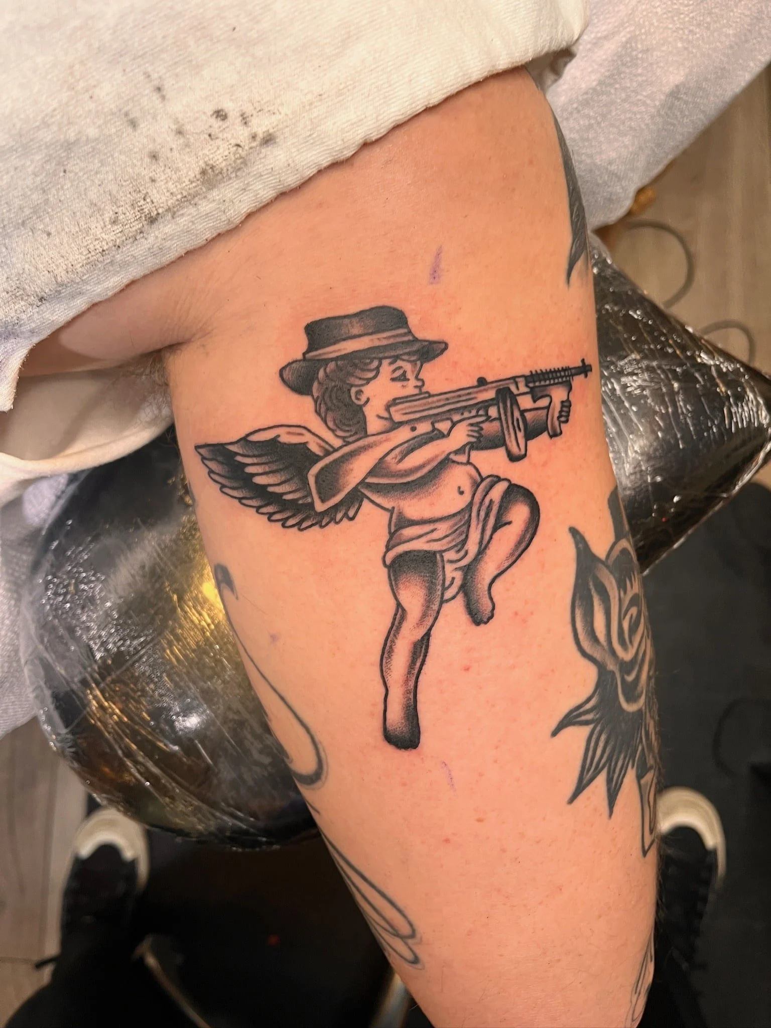 tommy-gun-cherub-traditional-black-grey-tattoo-arm.jpg