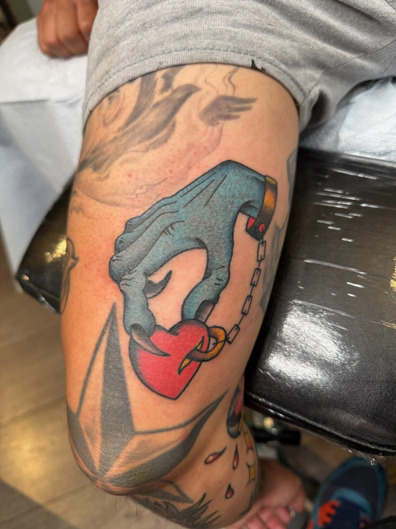 great-lakes-tattoo-chicago-hand-holding-heart-chain-traditional-tattoo.jpg .jpeg