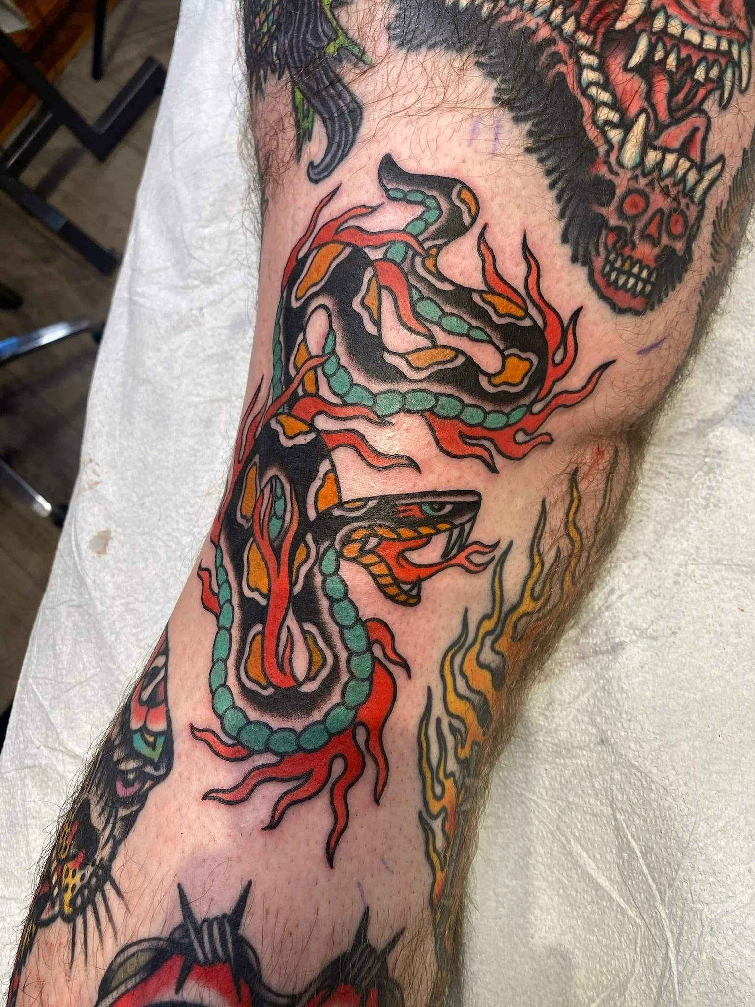 great-lakes-tattoo-chicago-traditional-fire-snake-tattoo-min.jpeg