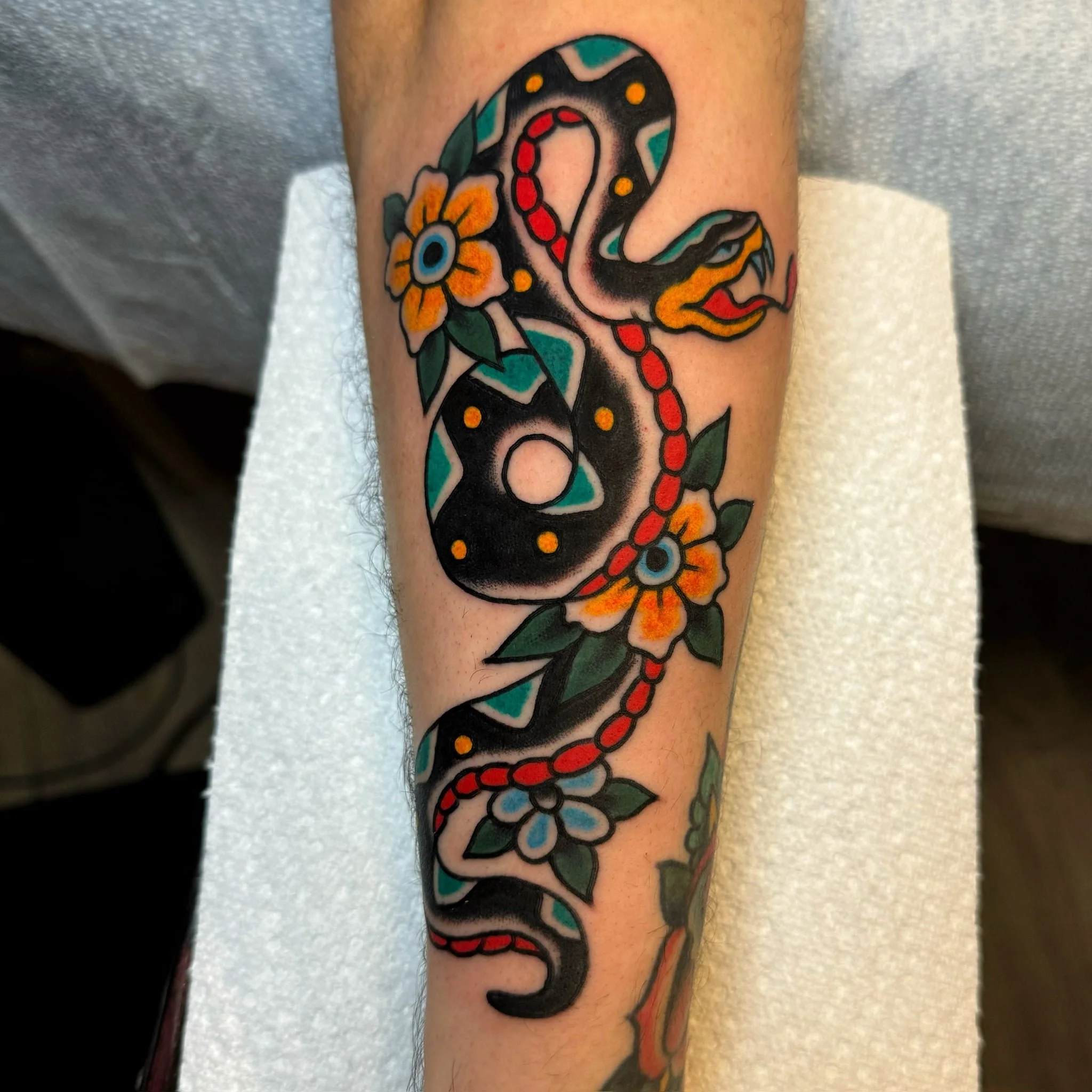 traditional-snake-and-flowers-chicago-great-lakes-tattoo-min.jpg