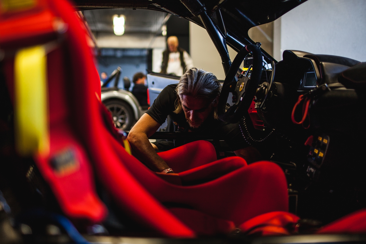  A group of technicians from Ferrari San Francisco came out to make sure Ben's car ran smoothly throughout the day. &nbsp;In this picture, Rudy is seen adjusting the seat to Ben's specifications. &nbsp; 