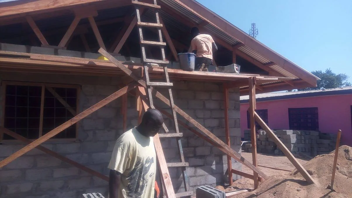 Laying brick on the gable ends, closing it off.