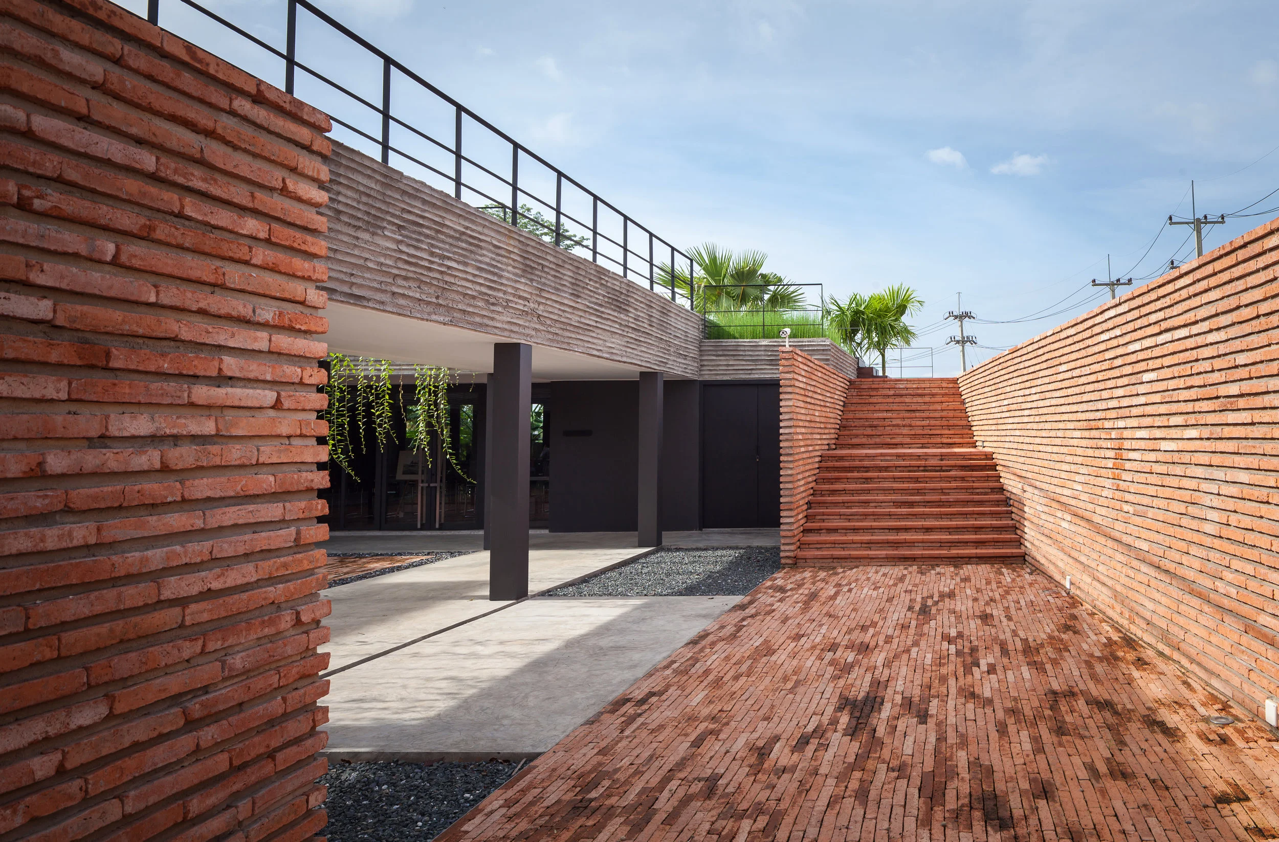 The main entrance is on the side lane and carved into the landform building creating the quite entrance space away from the highway.