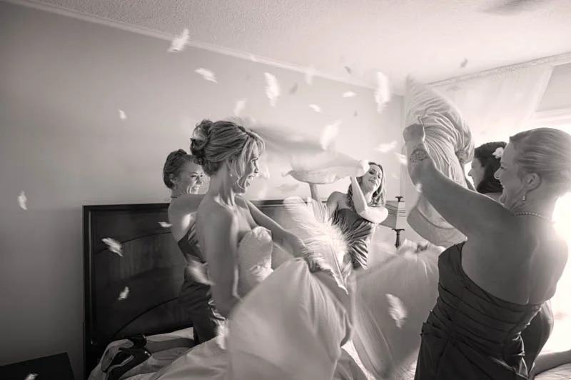 Bride and Bridesmaids have a pillow fight, just before the wedding.