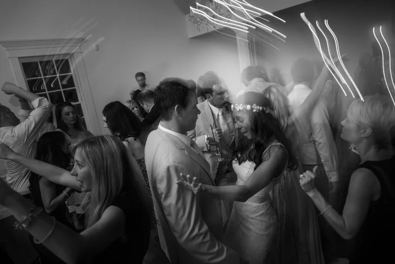 bride and groom celebrate with friend at the White Room's Villa Blanca reception site