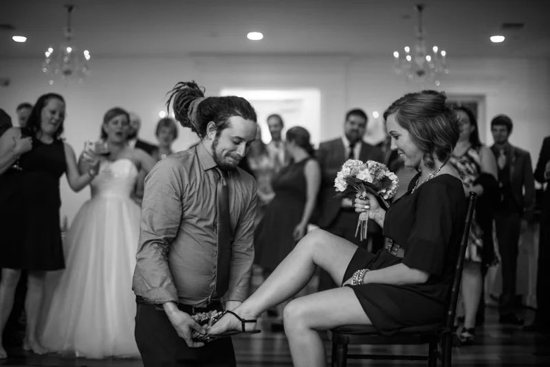 they guy who caught the garter puts it on the girl who caught the boquet at the White Room in St. Augustine, Florida