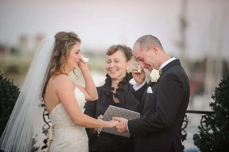 a bride and groom both cry during their ceremony on the rooftop at the White Room in St. Augustine, Florida