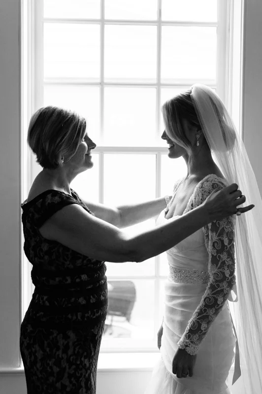 the bride and her mom take care of the final details just before the ceremony
