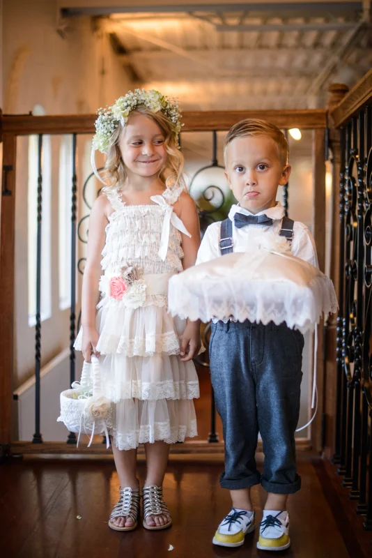 an adorable ring bearer and flower girl just before walking down the isle at the White Room in St. Augustine, Florida