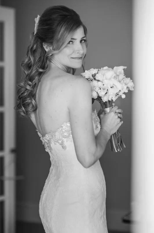 a bride poses with her bouquet at the White Room in St. Augustine, Florida