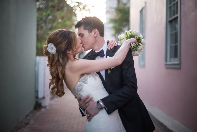 bride and grooms first kiss just downstairs from the White Room in St. Augustine, Florida