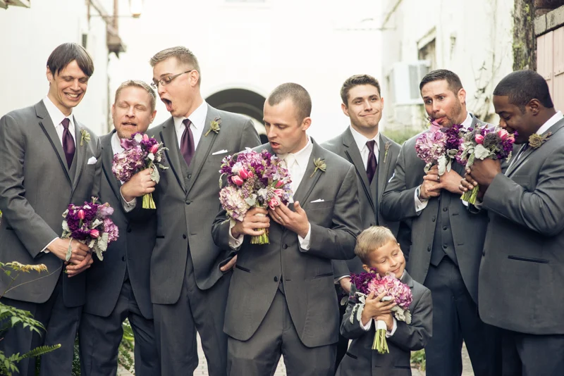 groomsmen pose with the bridesmaids bouquets just outside of the White Room in St. Augustine, Florida