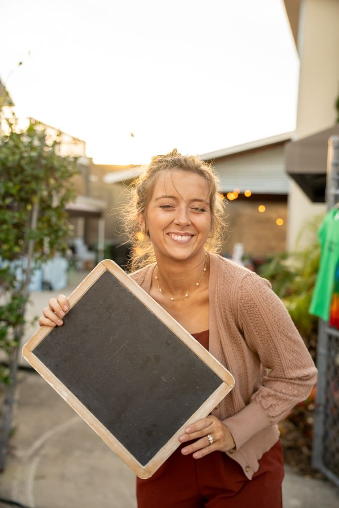 Smiling with a blank chalkboard.jpg