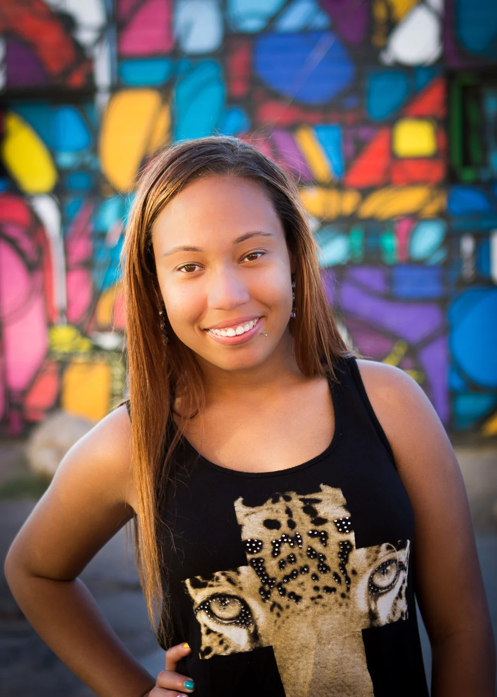 Marissa's session was a blast in downtown Phoenix. We found some cool spots with art/graffiti walls and dramatic colors. This image was lit with an off camera strobe and soft box. 