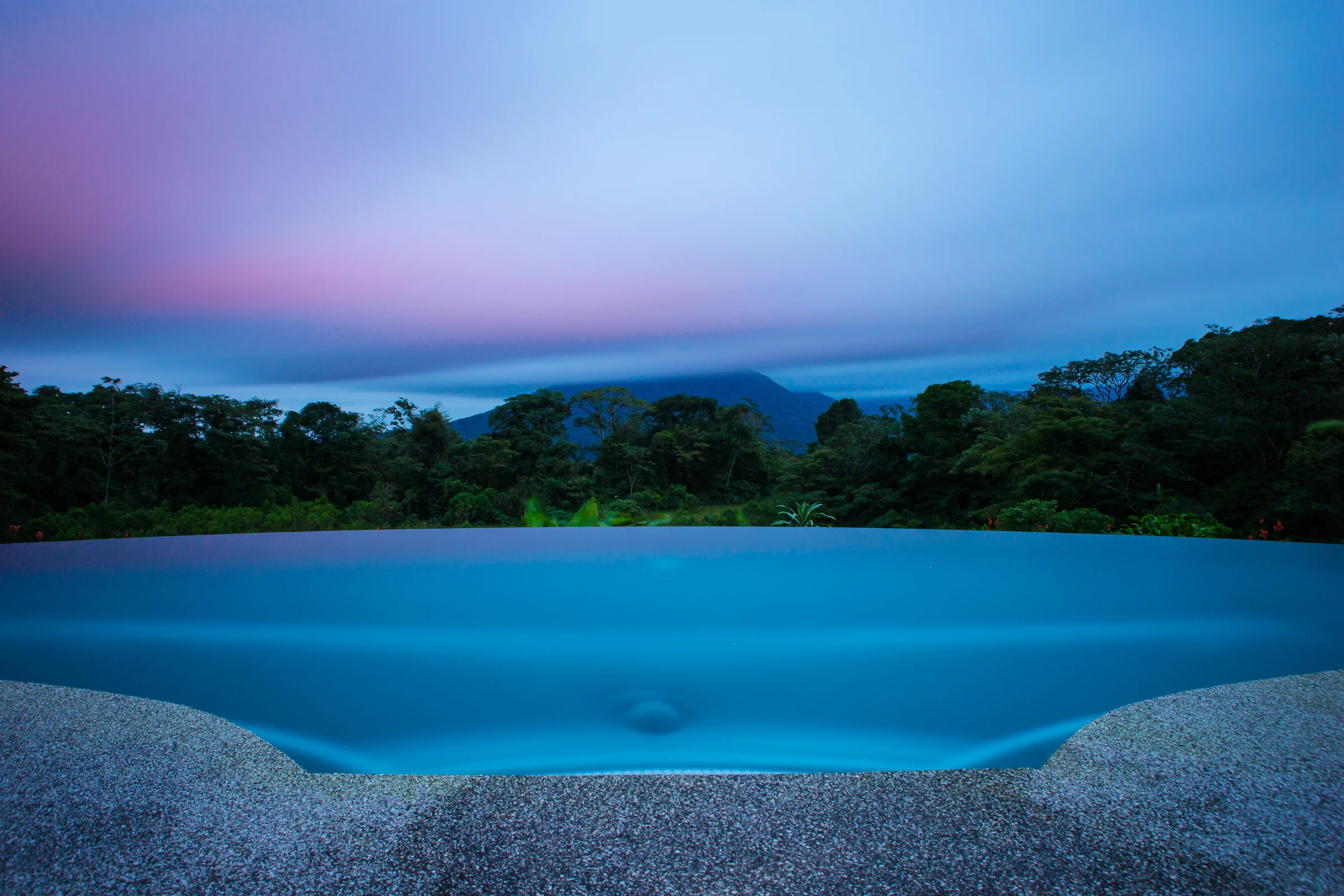 A long exposure at sunset, clouds now covering most of Arenal Volcano.