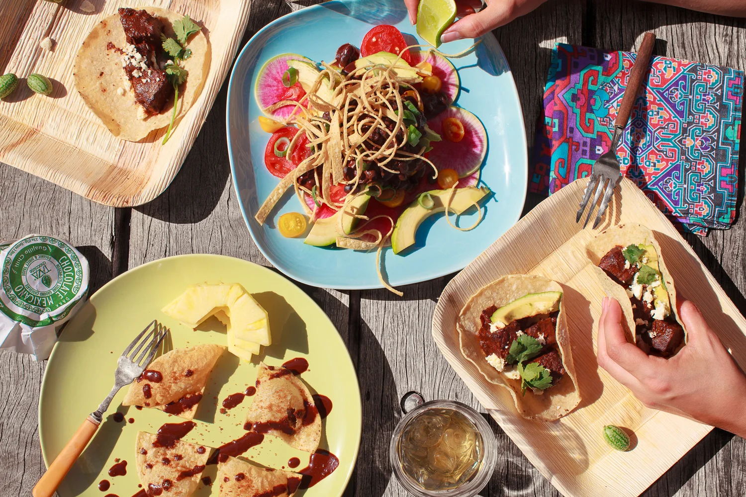 Crispy Tortillas with Guajillo Chocolate Sauce . Black Bean Salad with Chocolate Vinaigrette . Speedy Mole Beef Tacos . Bio-plates from Chef's Hat . Coloured plates from Ikea . Napkin made by my partners mother Maggie. Recipe and styling by Cle-ann , photo by Hugh Adams .