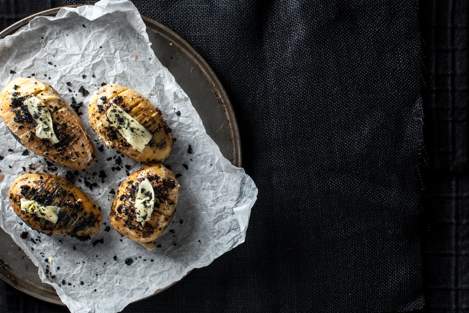 Hasselback Potato prep. Recipe and styling by Cle-ann , photo by Hugh Adams .