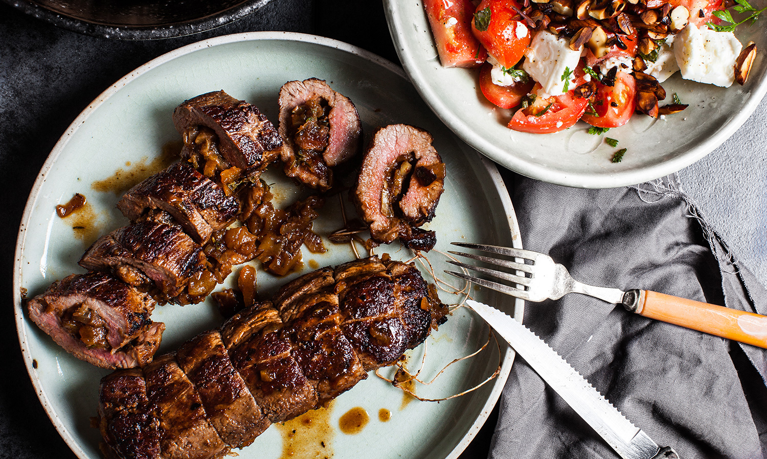 Date & Apricot Stuffed Lamb Backstrap w Tomato, Almond Salad. Recipe and styling by Cle-ann , photo by Hugh Adams .