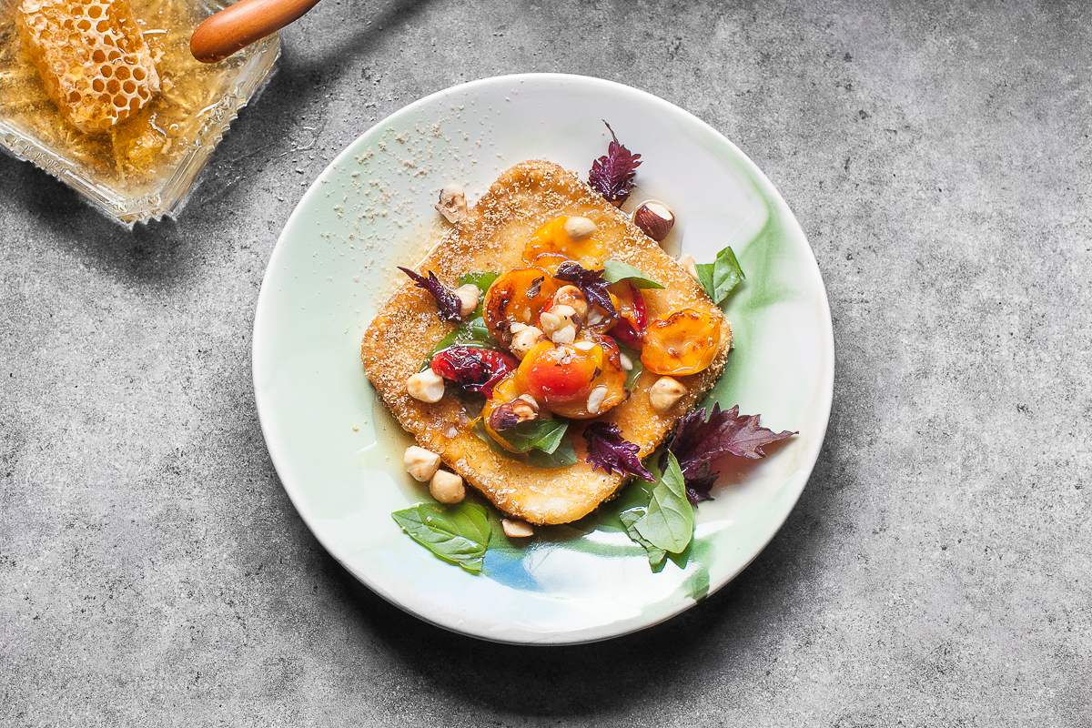 Saganaki with Plum, Basil and Honey. The Serene Series plate, created by Robert Gordon Australia exclusively for The Design Files . Recipe and styling by Cle-ann , photo by Hugh Adams .