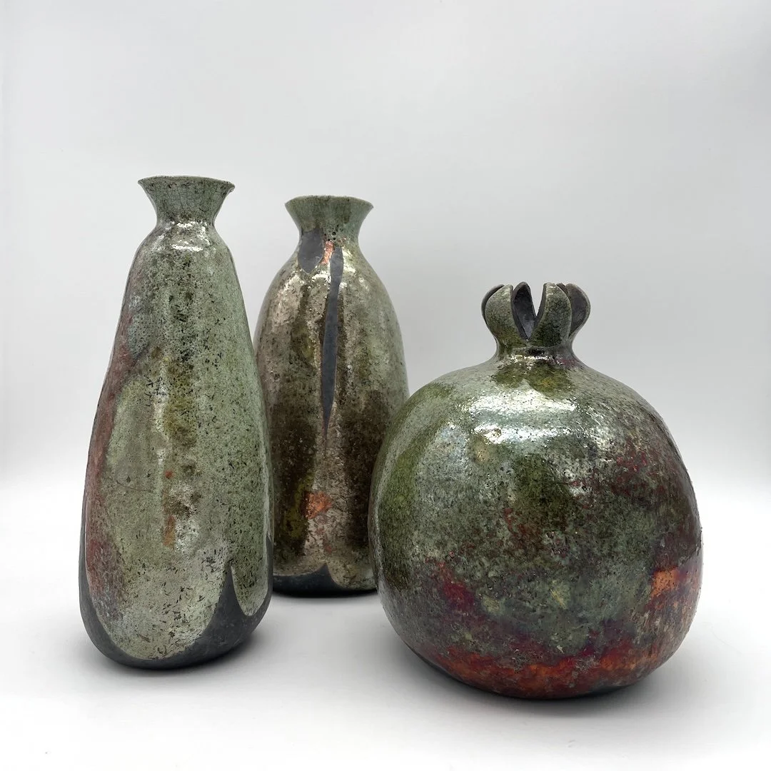  Raku-fired hand-built bottles and pomegranate. 