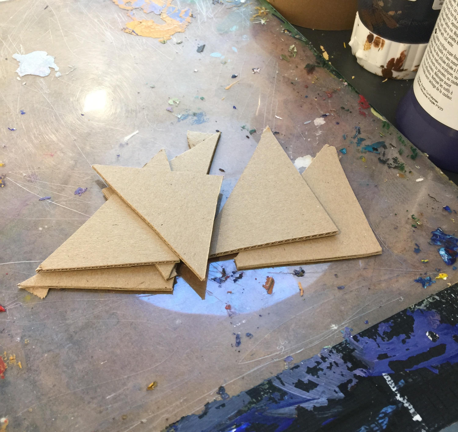 Cardboard wedges used to scrape paint on in block sections
