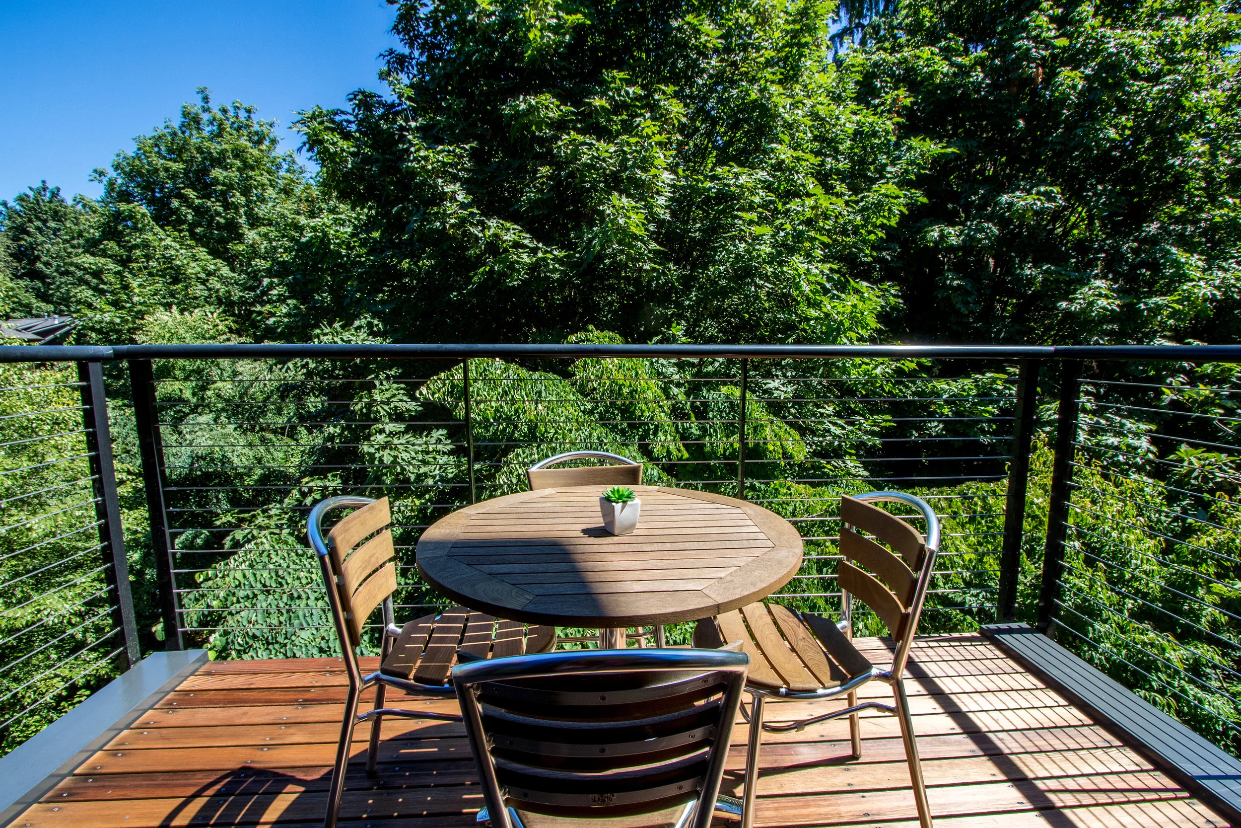 This deck off the living room is perfect for your morning coffee. You'll feel like you're on vacation every day with the rich, lush landscaping!