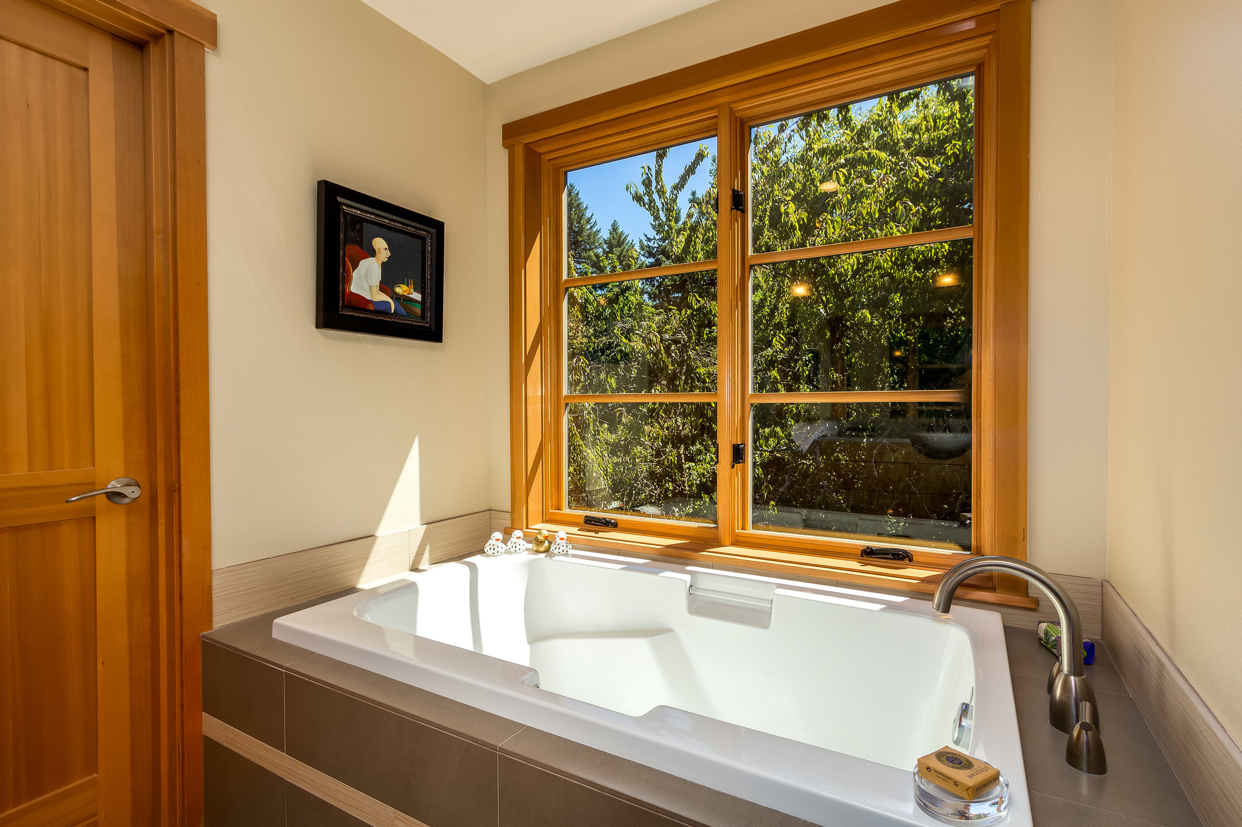 Master Bath soaking tub overlooks the lush landscaping.