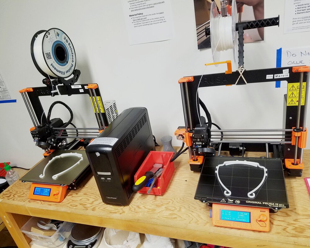 Photo by BARN: 3D printers working overtime to help with the COVID-19 response. BARN volunteers are using them to make components for face shields, PAPR hoods, and other protective gear so urgently needed by health care workers.