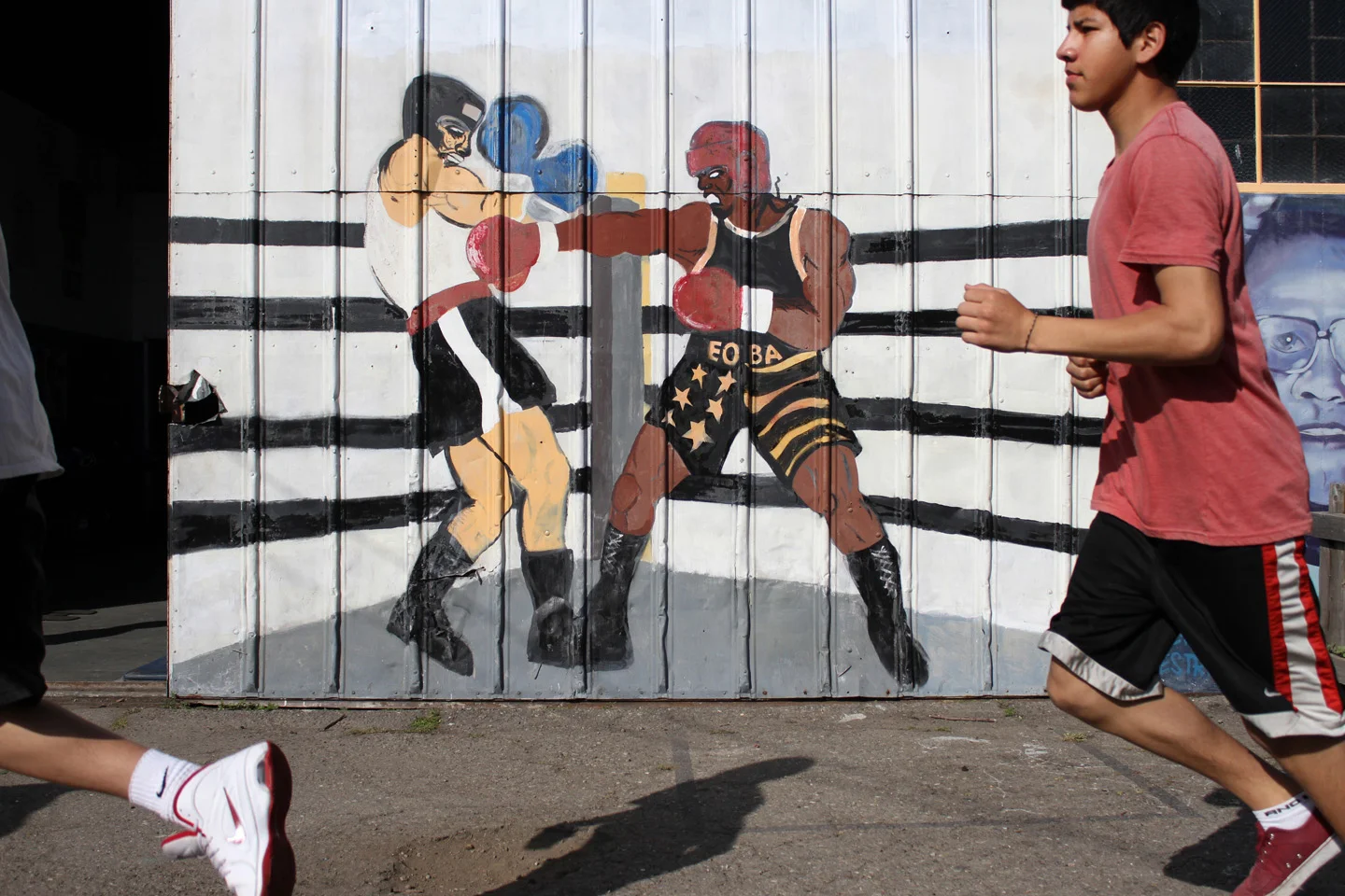 Young students at the East Oakland Boxing Association warm up before they start training in the gym.