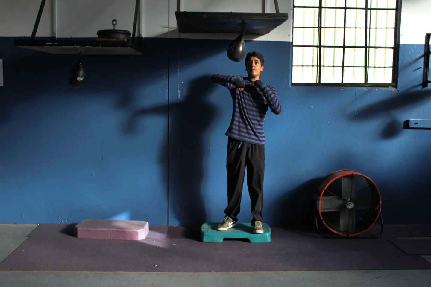 Antonio Munguia, 15, practices his speed and accuracy alone in the gym.