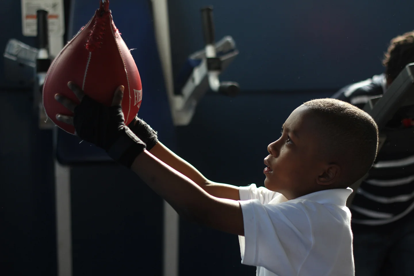 Kharai Marshall, 7, tries to still the punching bag after he learns how to use it for the first time.