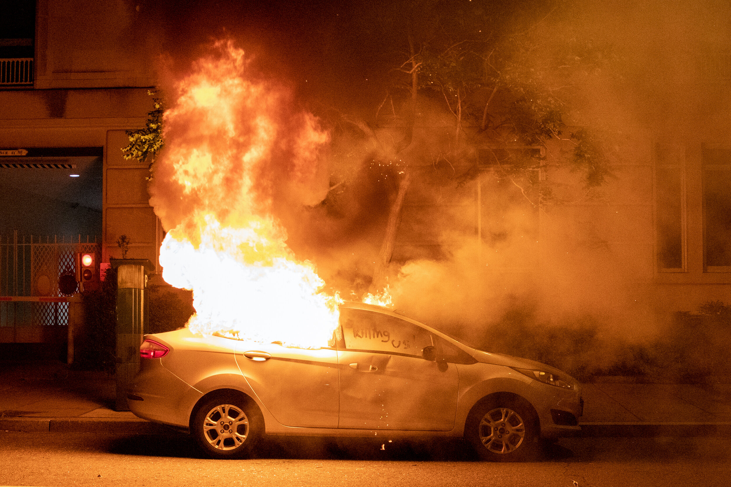 Protesters burned out a car during a rally against police brutality against unarmed black men following the death of George Floyd, who was killed in Minneapolis, Minnesota, near the White House in Washington, D.C., USA on Sunday, May 31, 2020. (Phot