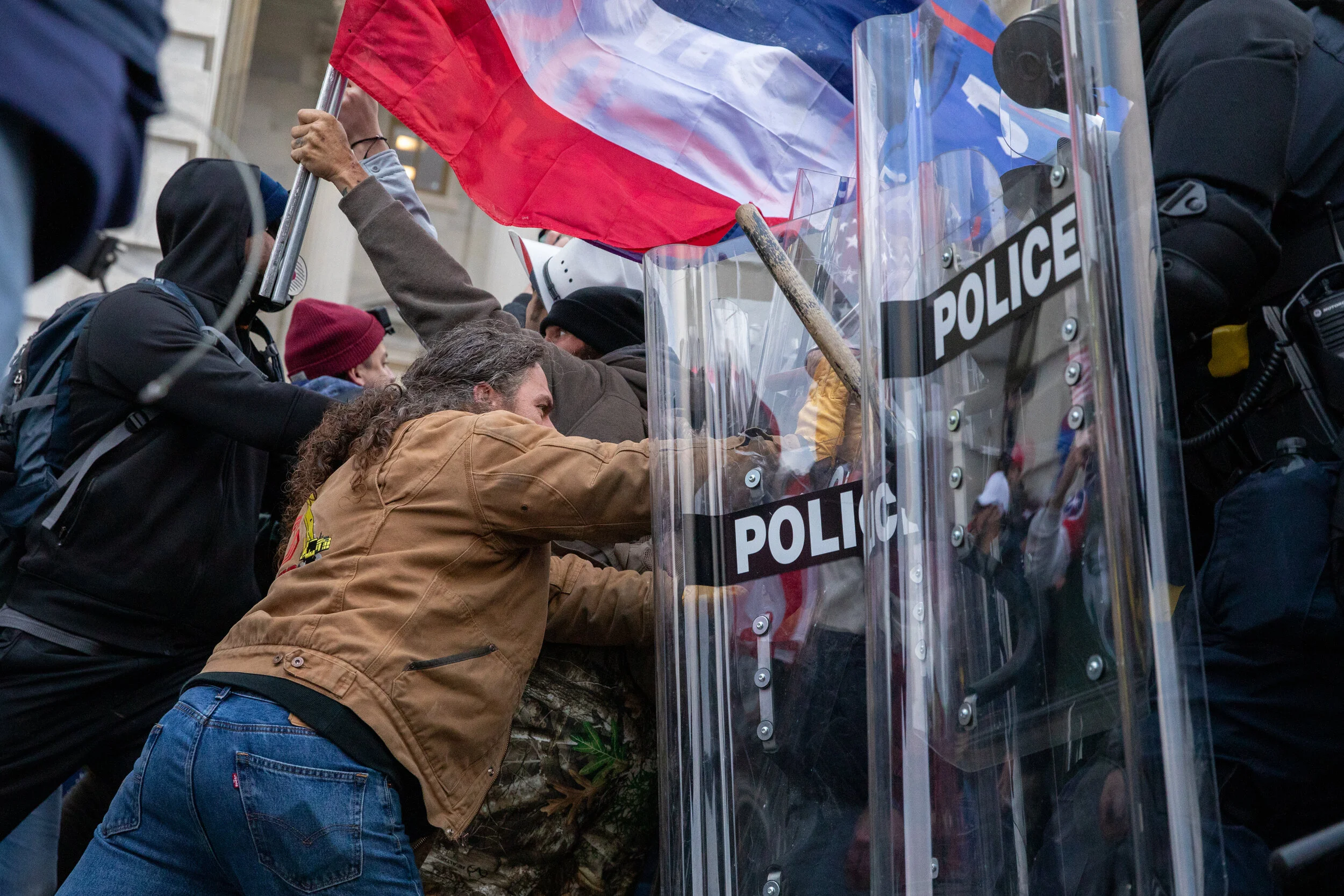  A man pushes back police forces amid as Pro-Trump rioters infiltrated the U.S. Capitol on January 6, 2021. (Photo made for The Washington Post) 