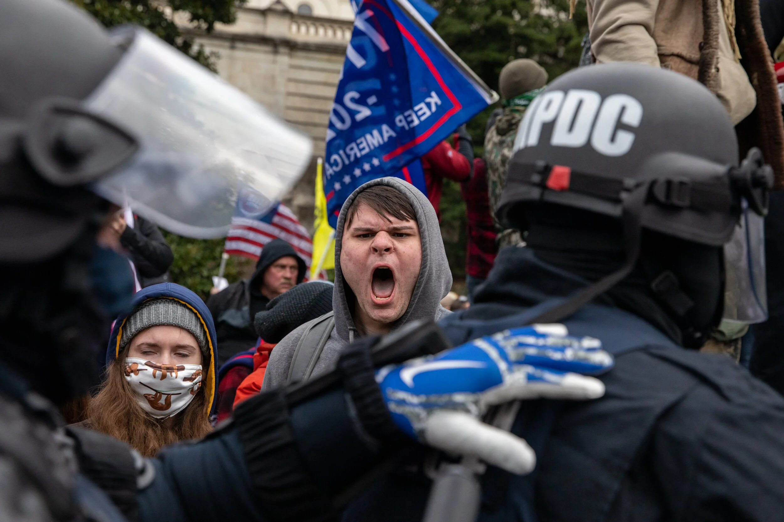  A Pro-Trump rioter screams at police officers amid an insurrection that resulted in the boundaries of the US Capitol being breached on Wednesday, January 6, 2021. (Photo made for The Washington Post) 