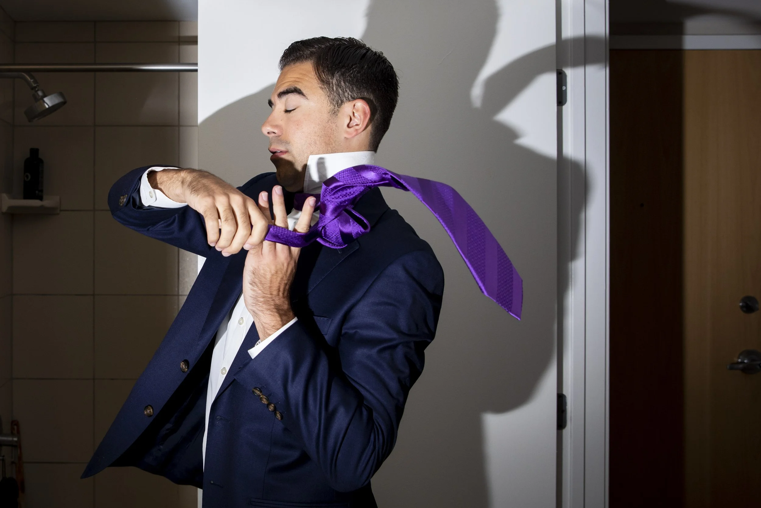 Influencer Anthony Polcari, better known as his online moniker Tony P, looks in the mirror as he ties his tie at his home in Washington, D.C. on August 31, 2023. (Amanda Andrade-Rhoades/For The Washington Post) 