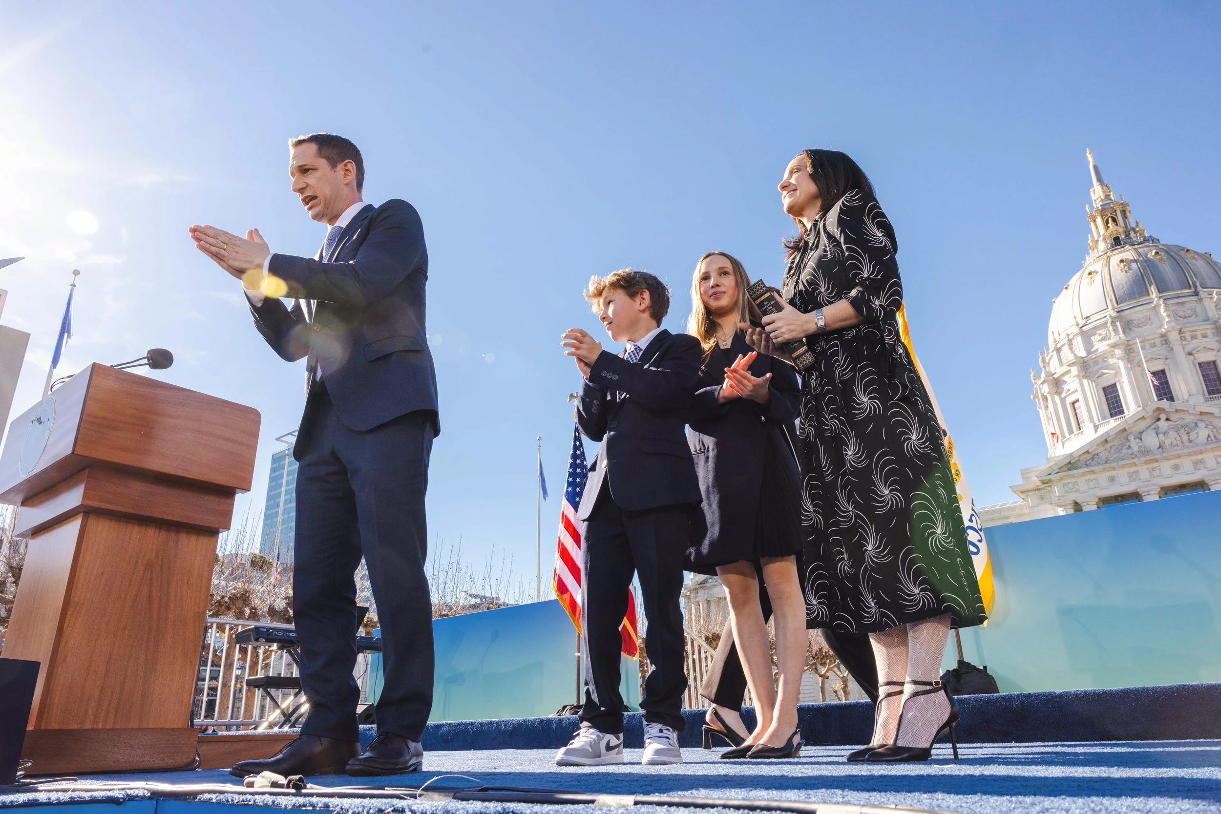 Mayor Daniel Lurie, left, looks out alongside his family, Sawyer Lurie, Taya Lurie and wife Rebecca Lurie in front of City Hall in San Francisco on Wednesday, Jan. 8, 2025. Daniel Lurie, a member of the Democratic Party and heir to the Levi Strauss