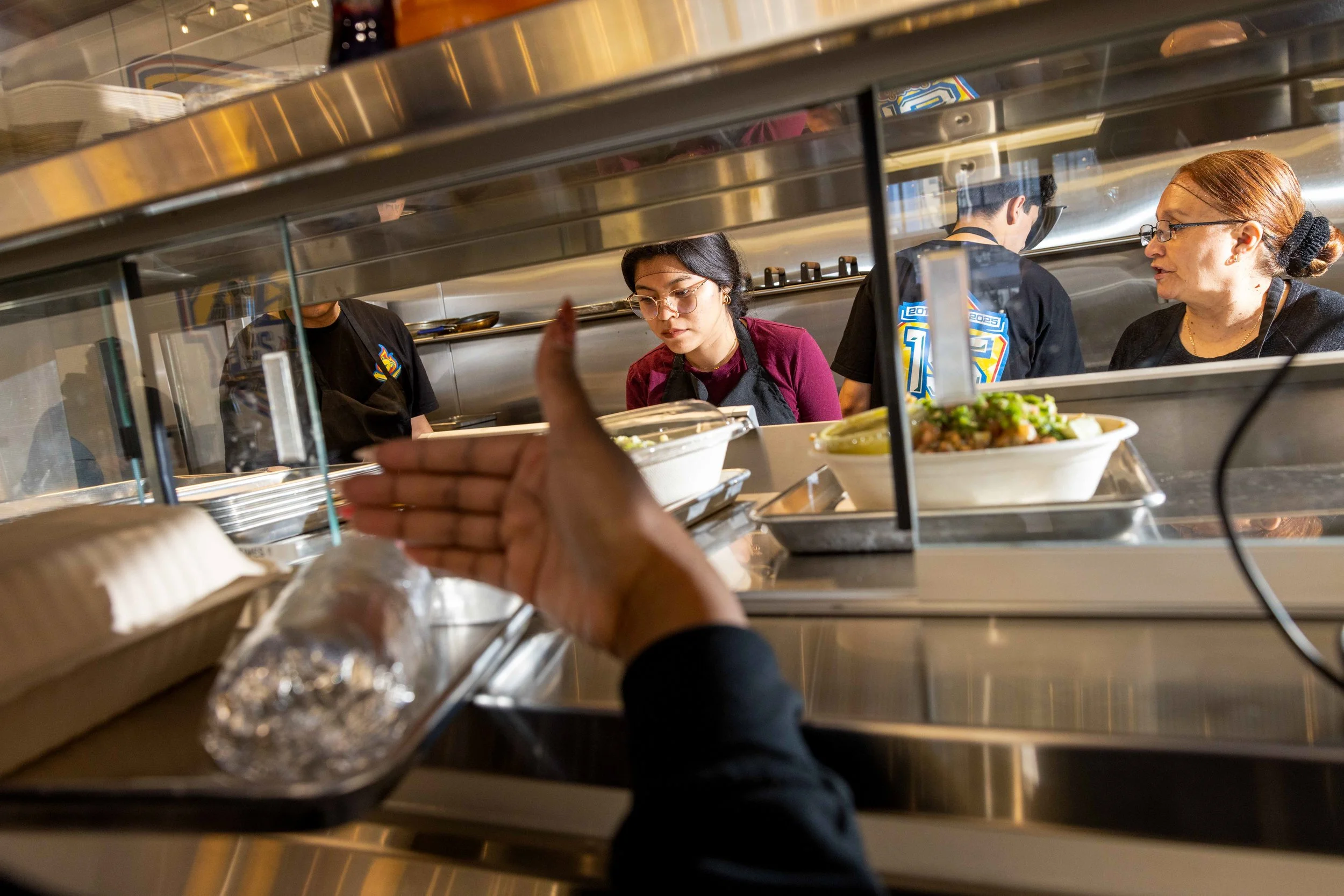The kitchen staff of Señor Sisig works through lunch orders near the Chase Center in San Francisco on Monday, Feb. 10, 2025. (Amanda Andrade-Rhoades/The San Francisco Standard)