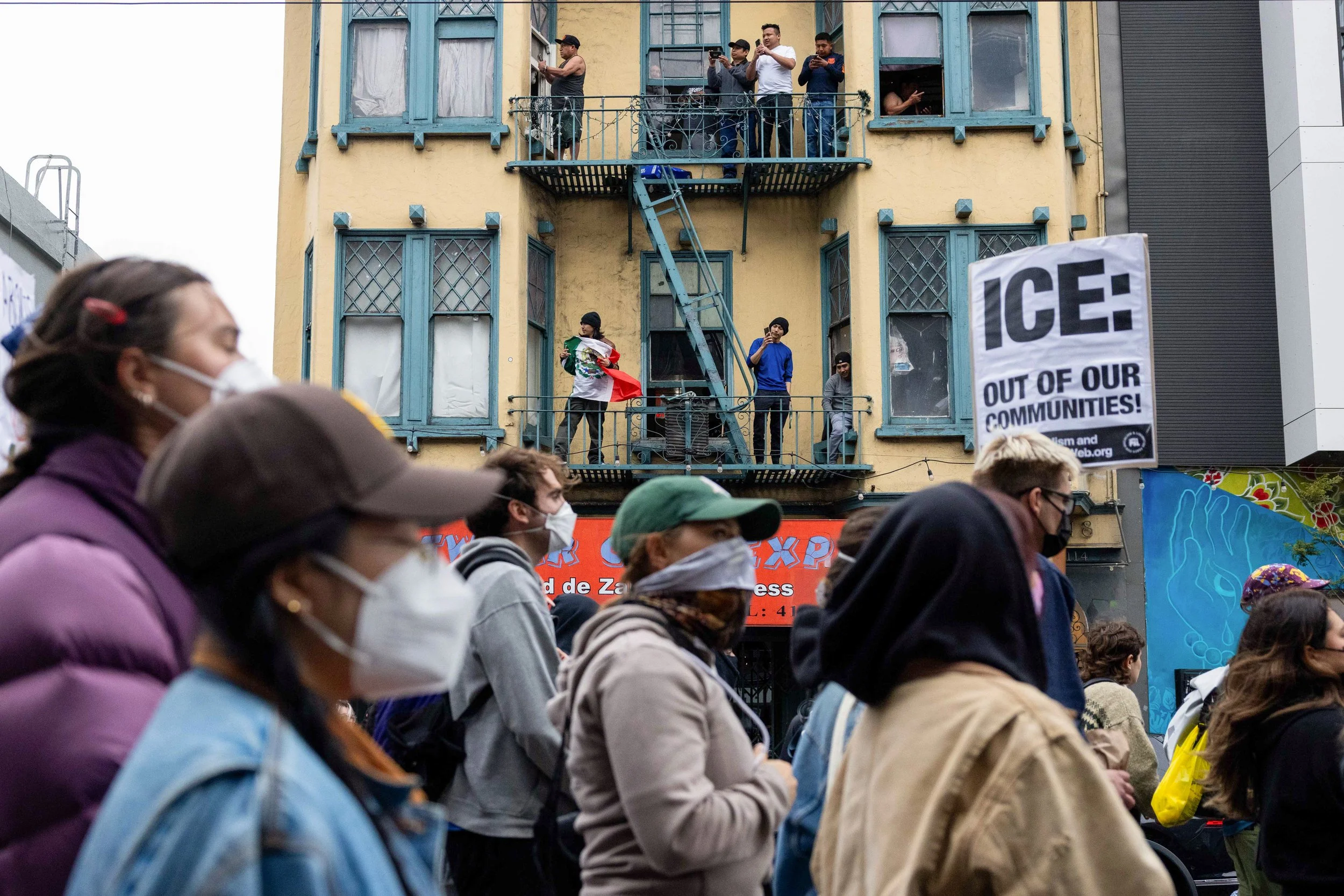  An onlooker holds a Mexican flag during a protest against Immigration and Customs Enforcement (ICE) raids at 24th and Mission in San Francisco on Monday June 9, 2025. (Amanda Andrade-Rhoades/The San Francisco Standard) 