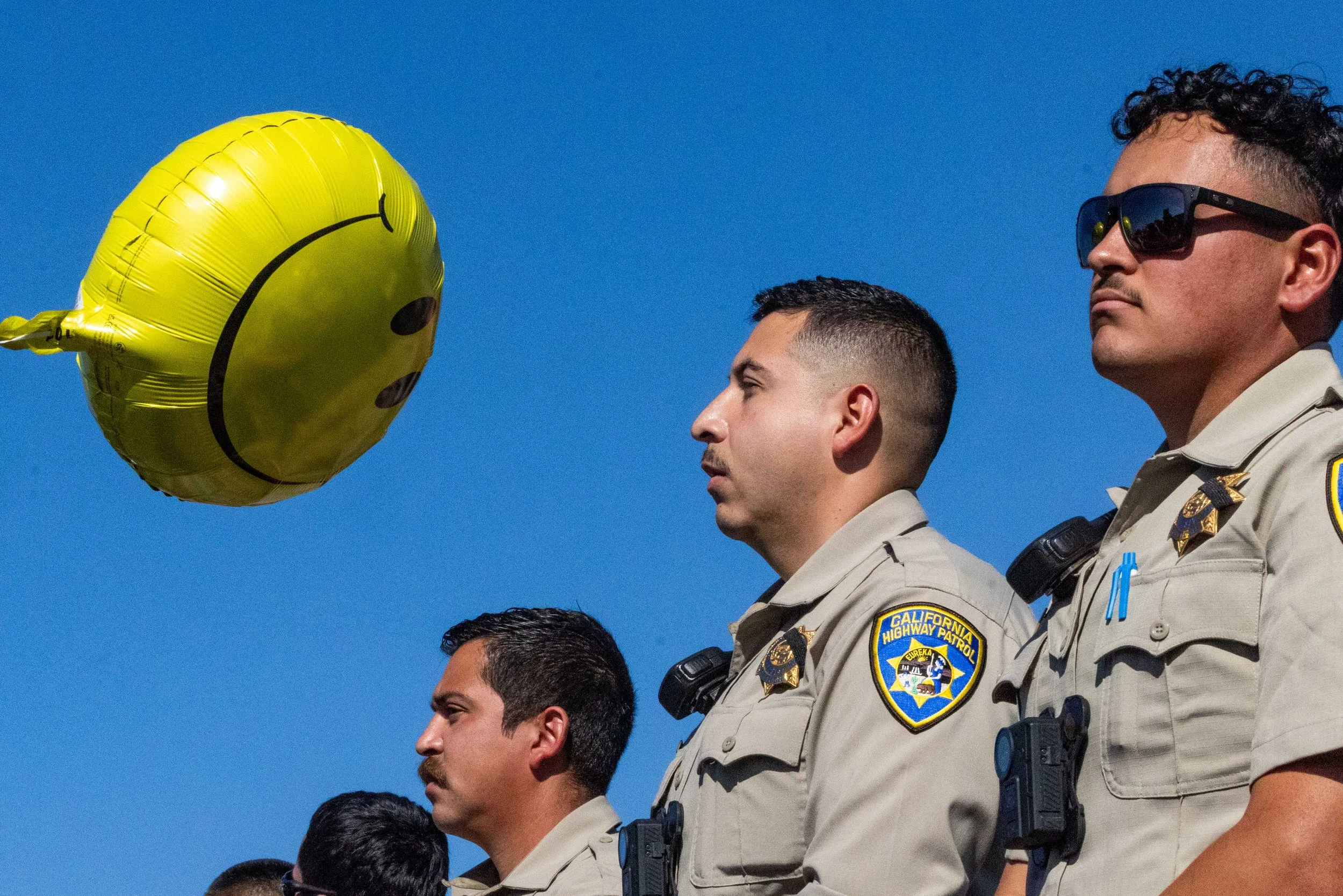  California Highway Patrol officers face a balloon near the entrance of Coast Guard Island in Alameda on Thursday, October 23, 2025. Federal immigration authorities were set to use the island as a base of operations. (Amanda Andrade-Rhoades/The San F