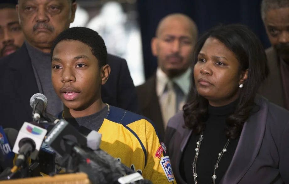 Photo: Scott Olson / Getty Images Brandon Green, a player for the Jackie Robinson West Little League baseball team, speaks alongside his mother, Venisa.