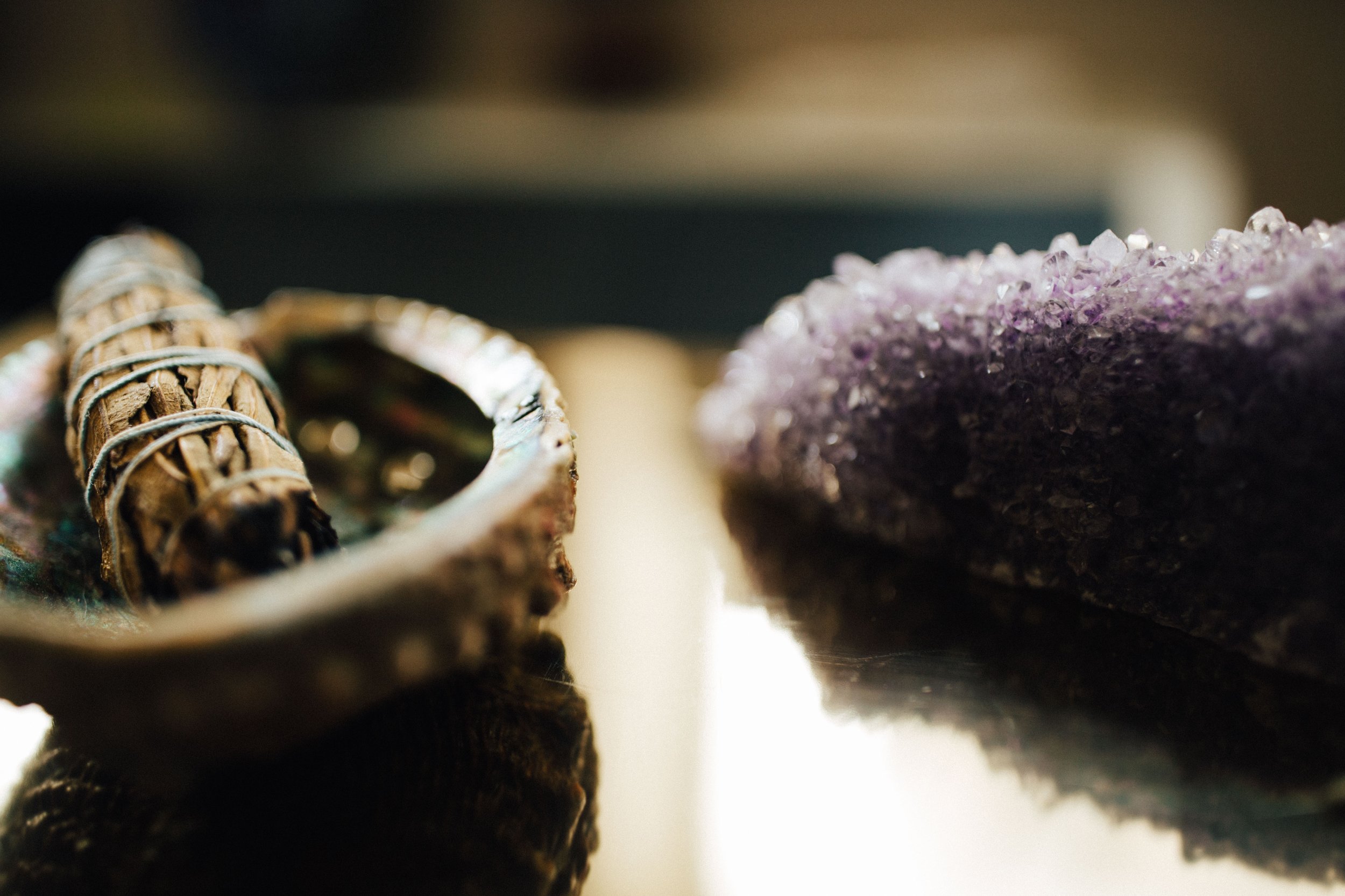  image of medicinal herbs and a purple crystal 