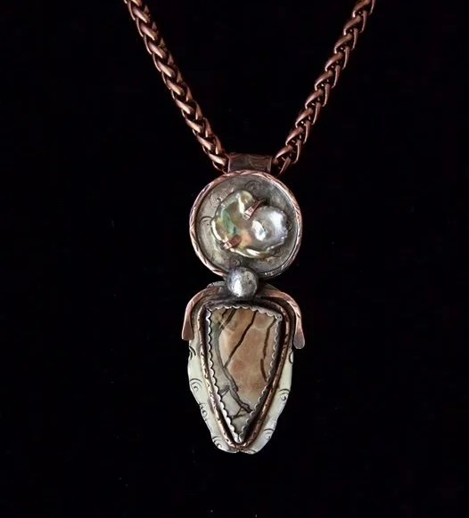"Following Destiny" combines two pieces of nature – a freshwater pearl and a Utah Septarian stone cut by Jeff Hansen, AZ – set in mixed metals: sterling silver and copper. Jo E. Caruso says ~ “That is more than incredible. I love the freshwater pearl addition. Just beautiful!!! I just had to share with you how this piece affected me when I received it. It felt like it finally made it home. Along with a lot of energy from the artist. The picture doesn’t do it justice. Thank you, Kathi. For sharing your gift.