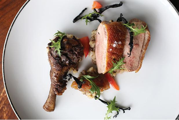 The pan-roasted duck breast, jerk wing with dirty rice, pickled peppers, shallot marmalade and crispy black trumpet mushrooms, from the “land & air” section of the Salare menu